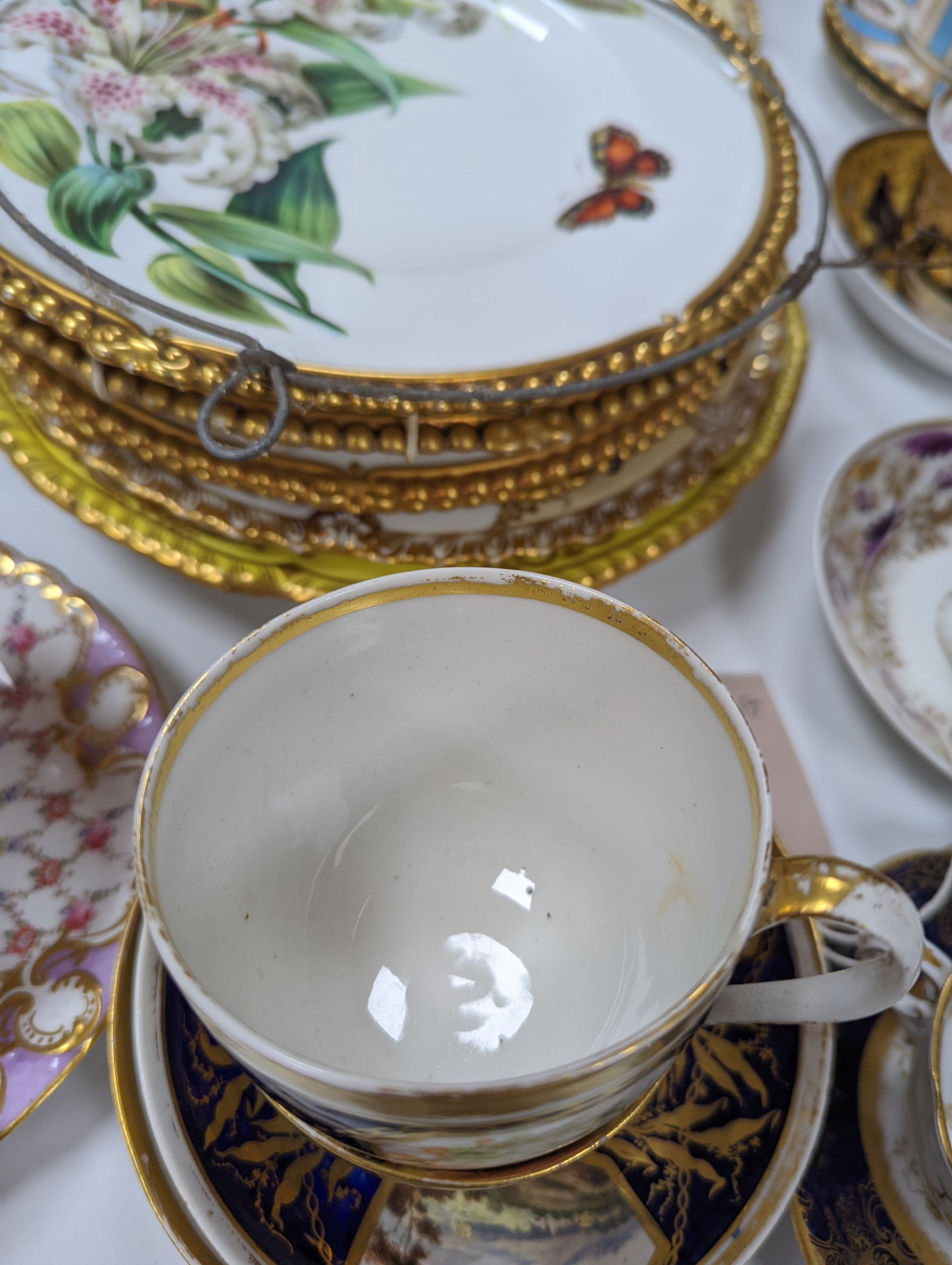 A small collection of Victorian porcelain tea cups and saucers and sundry dessert plates